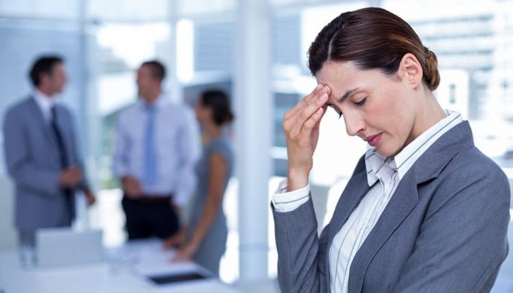 Worried businesswoman with head in one hand