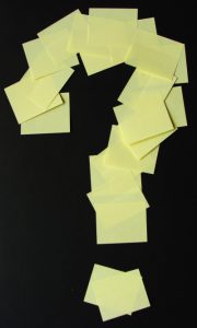 Image of post-it notes in the shape of a question mark for an article about What to Expect in a Reverse Auction.